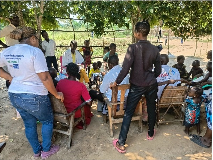 Community Health Meeting on Immunization A local health meeting takes place outdoors, with villagers gathered to discuss the importance of immunization and health initiatives.