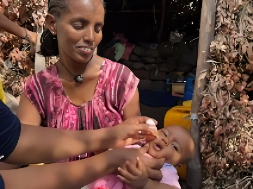 Ethiopia - mother A child receiving nOPV2 vaccine during the campaign in Abbi Addi