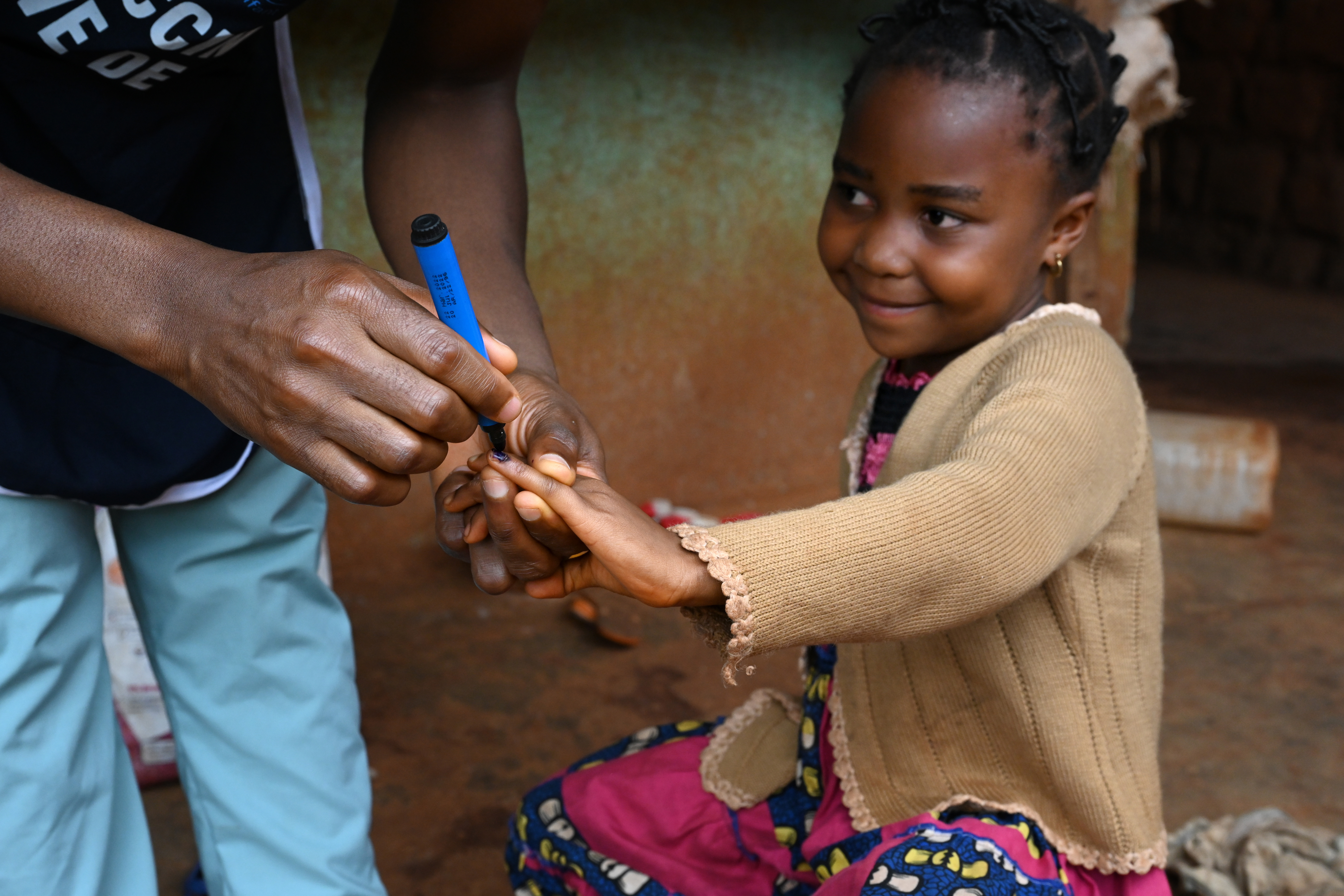 Little girl getting their pinky marked