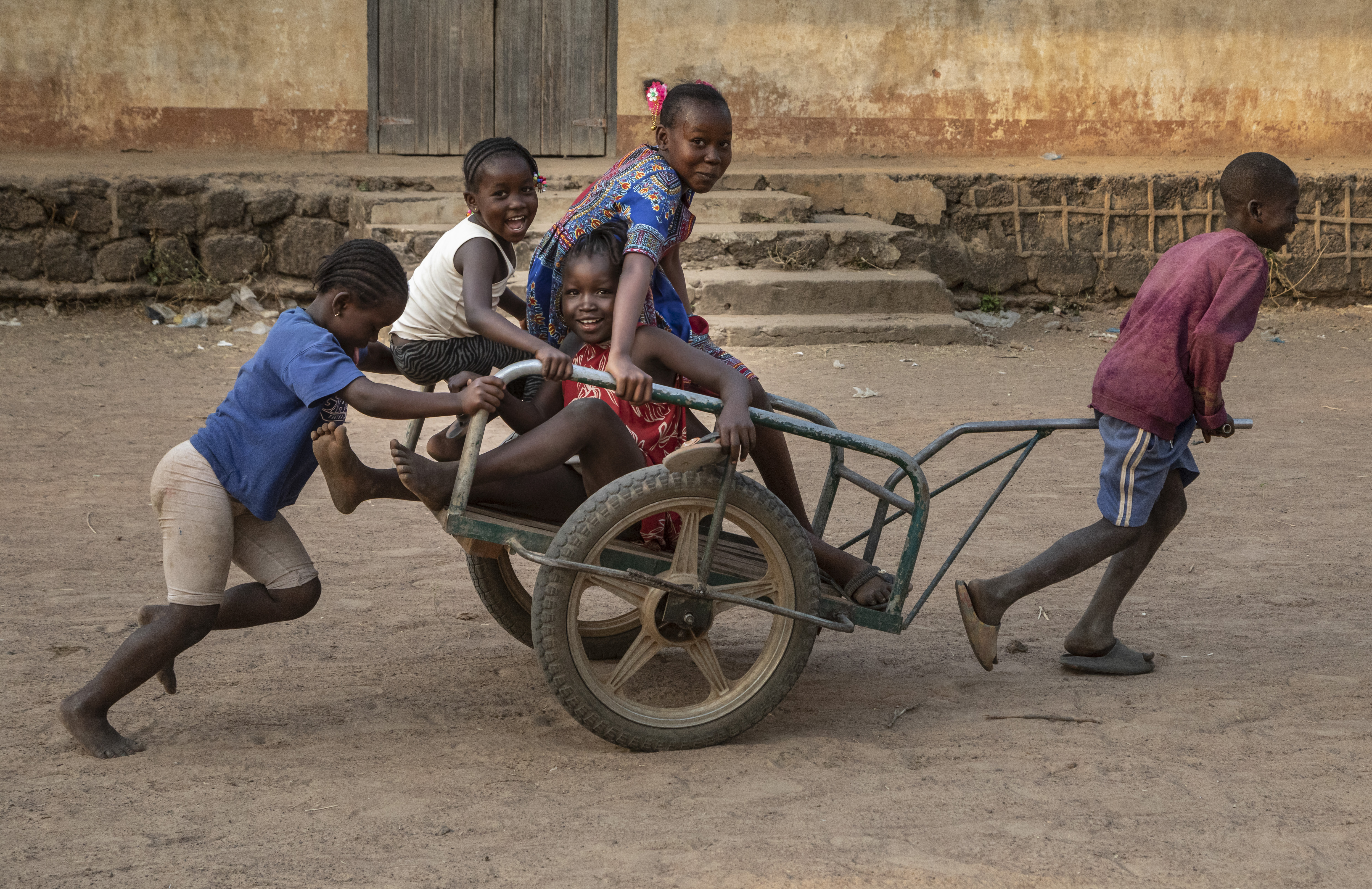Children playing on top of a cart