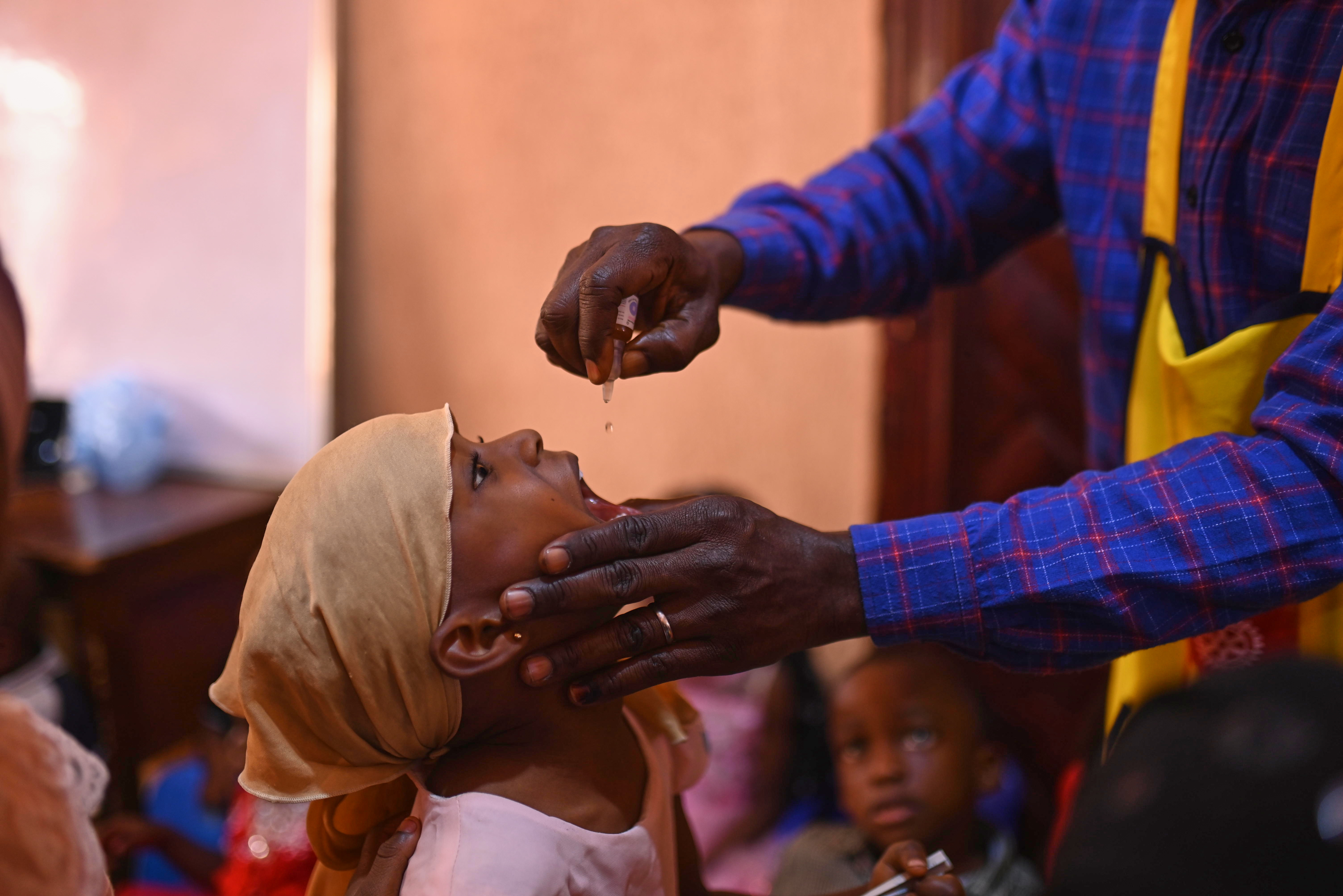 Children taking the polio vaccine drops
