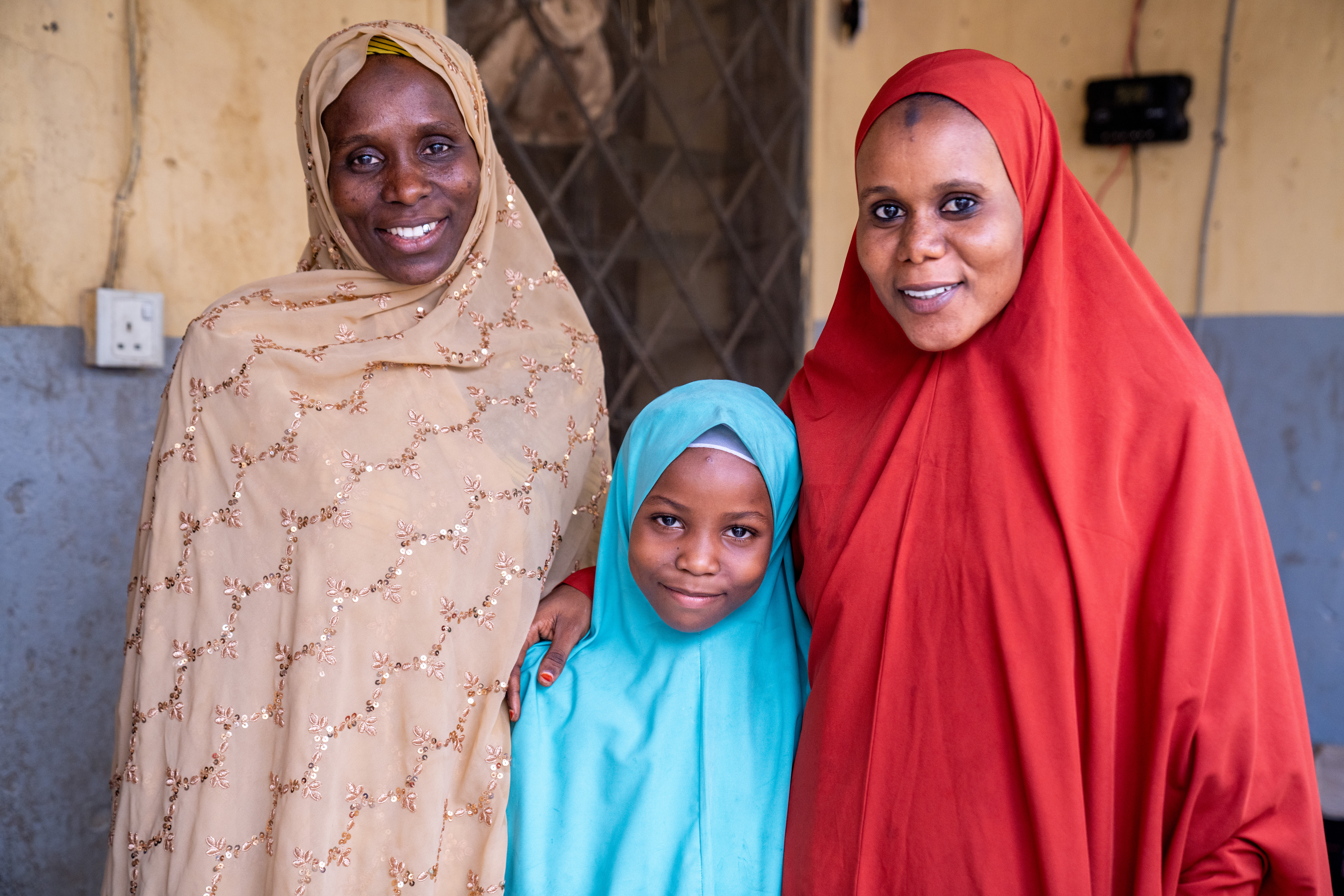Two woman and a girl looking at the camera