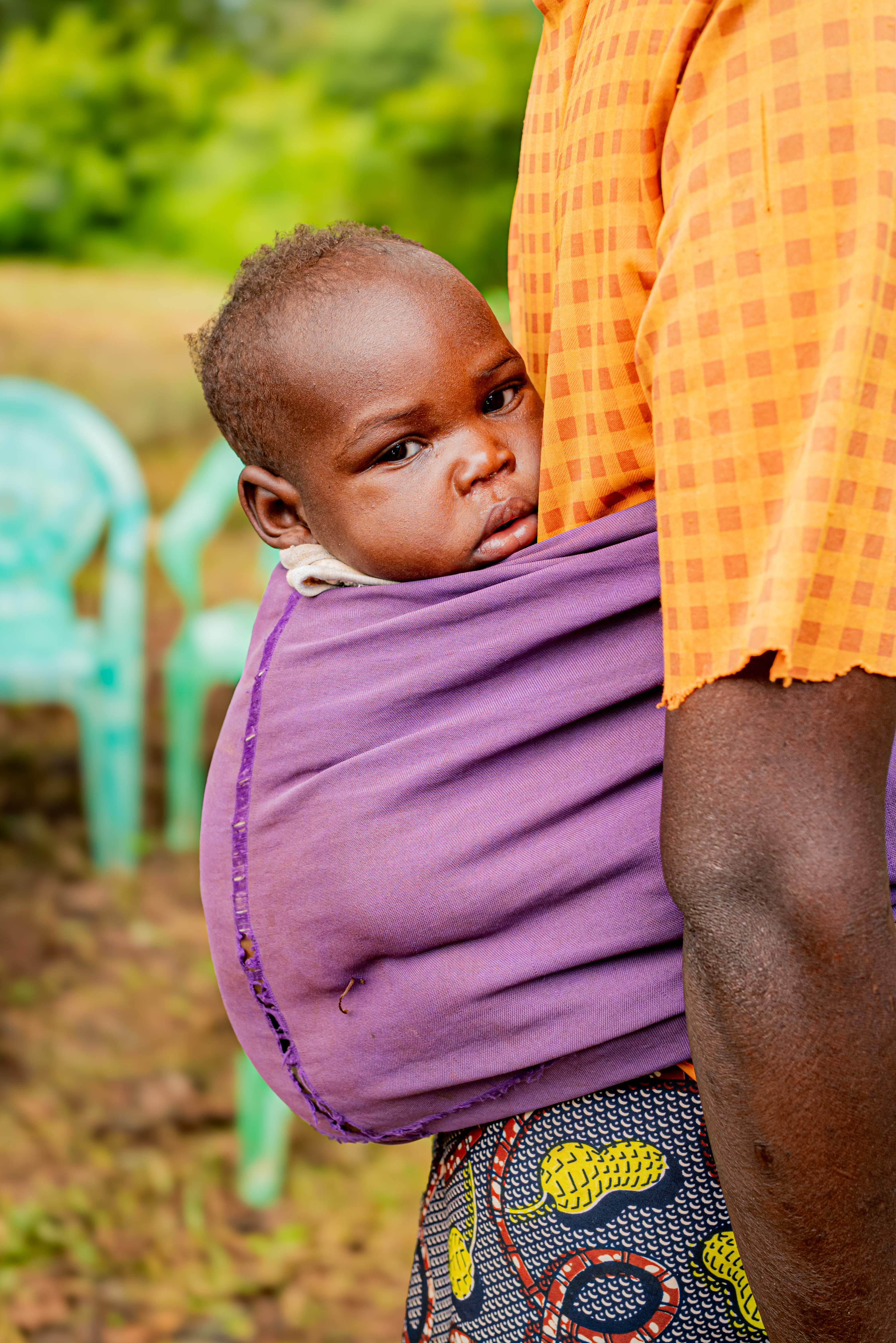Children being held in their mother’s back