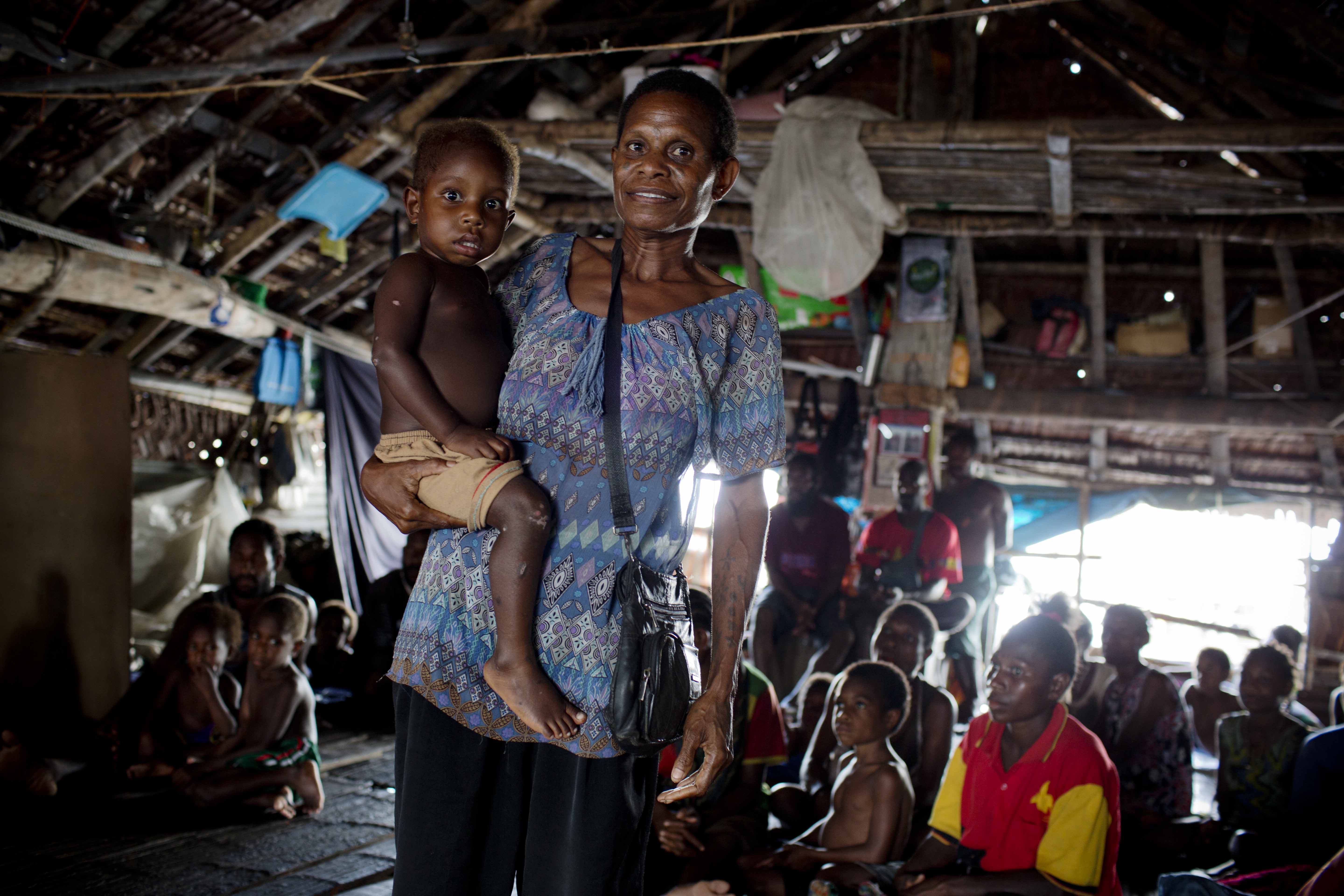 Woman holding child and smiling