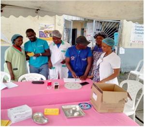 A group of healthcare workers, including UNICEF staff, prepare materials for a polio vaccination campaign at a health center in Cameroon.