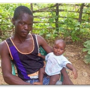 Félix Yvon Béfio and his baby who has just received the polio vaccine.