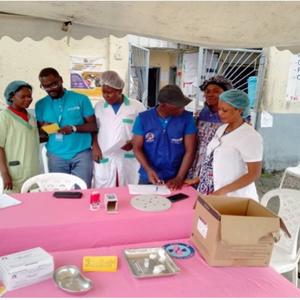 A group of healthcare workers, including UNICEF staff, prepare materials for a polio vaccination campaign at a health center in Cameroon.