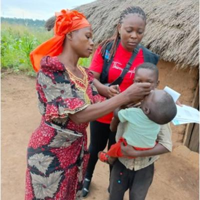 Mrs. Josephine administering a polio vaccine to a child during her door-to-door campaign in the Dibaya Health Zone. Photo: UNICEF/2024/DRC