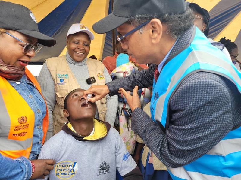 Health Specialist, Dr. Sethy giving a polio vaccine to a boy during a polio vaccine launch