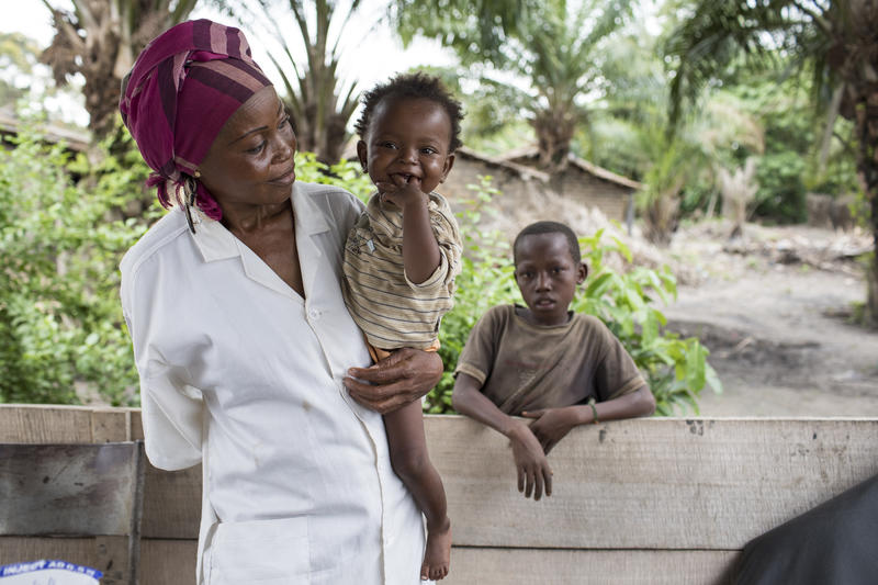 Woman holding child and smiling