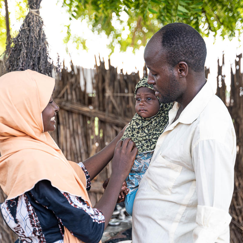 parents looking and smiling at their baby