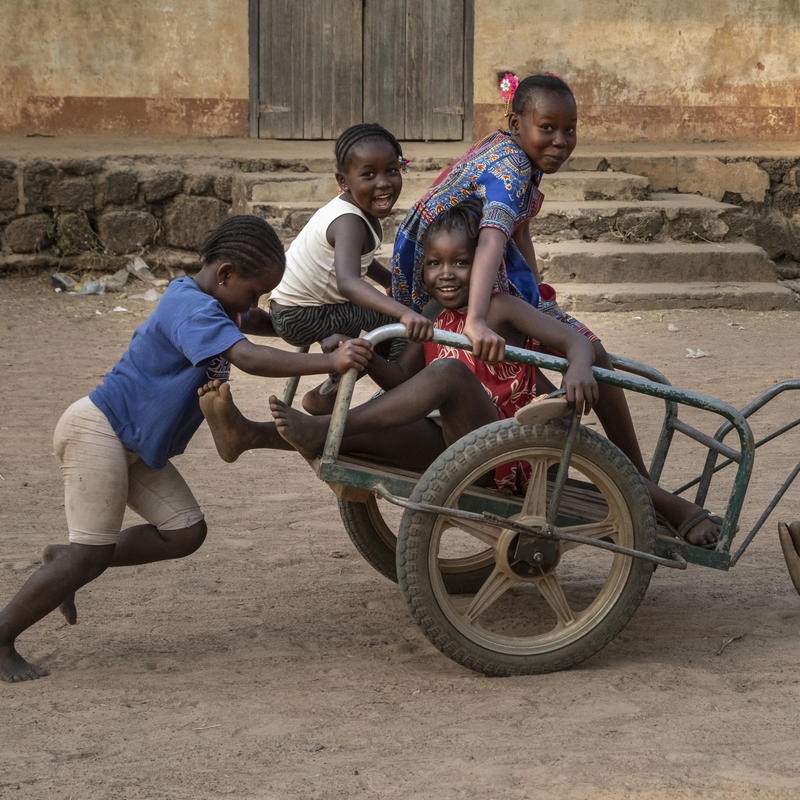 Children playing on top of a cart