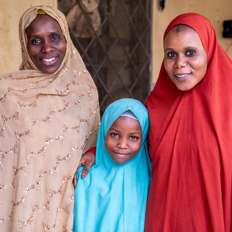 Two woman and a girl looking at the camera