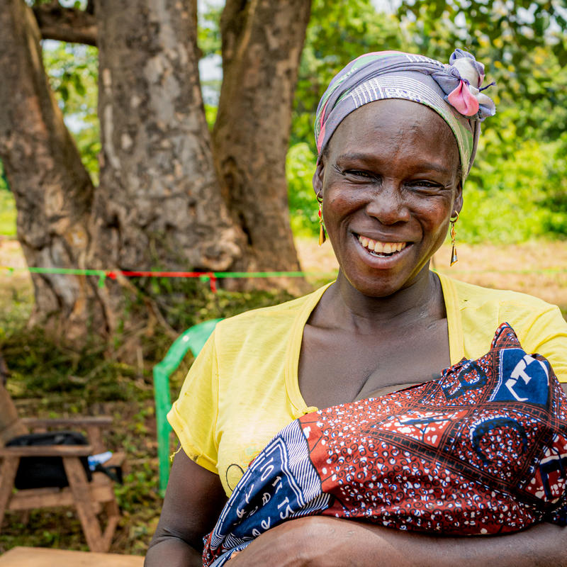 Mom holding her baby and smiling