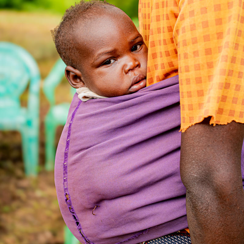 Children being held in their mother’s back