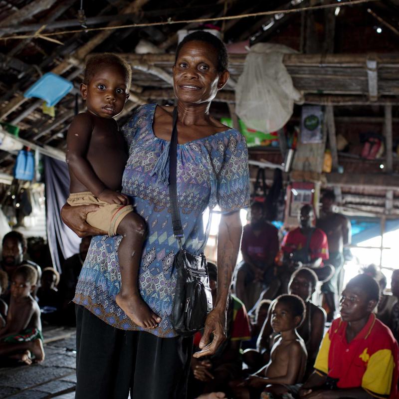 Woman holding child and smiling