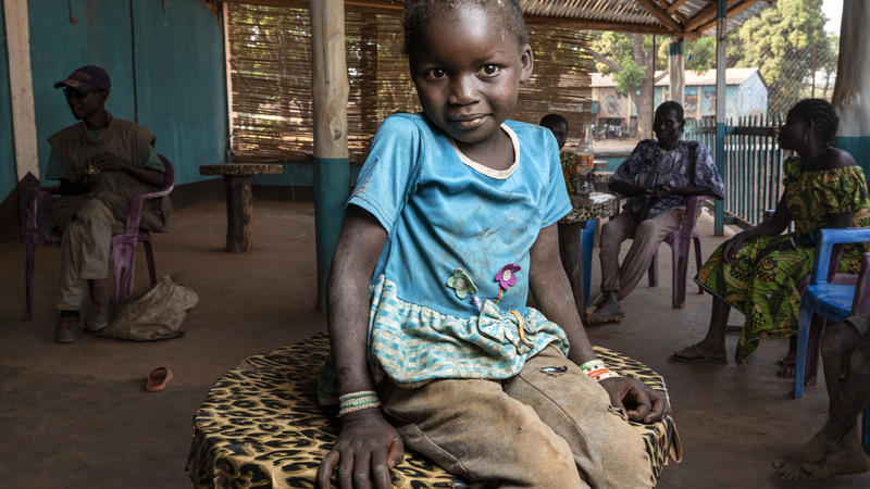 Child looking at the camera and smiling slightly