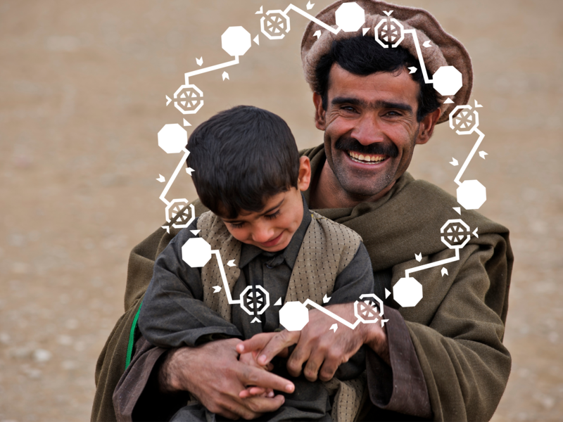 Father holding his son, they are both smiling