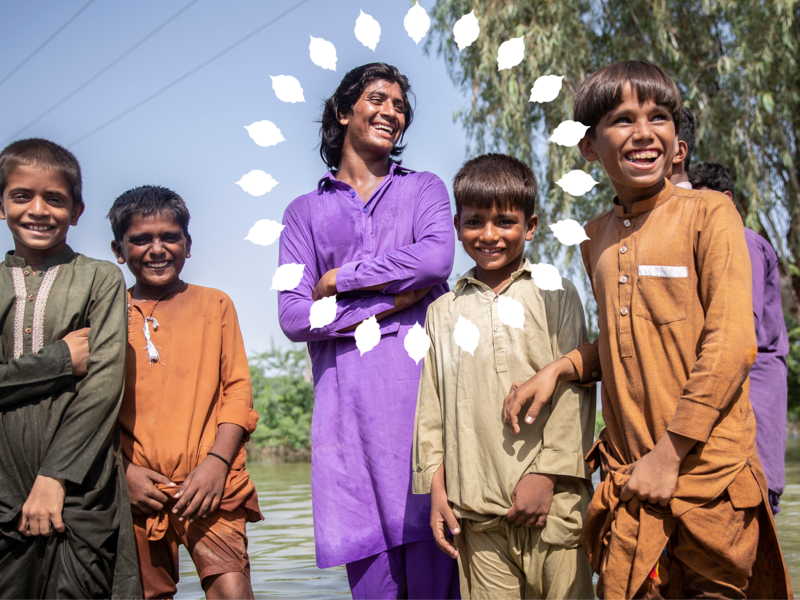 A group of children of different ages laughing on the street
