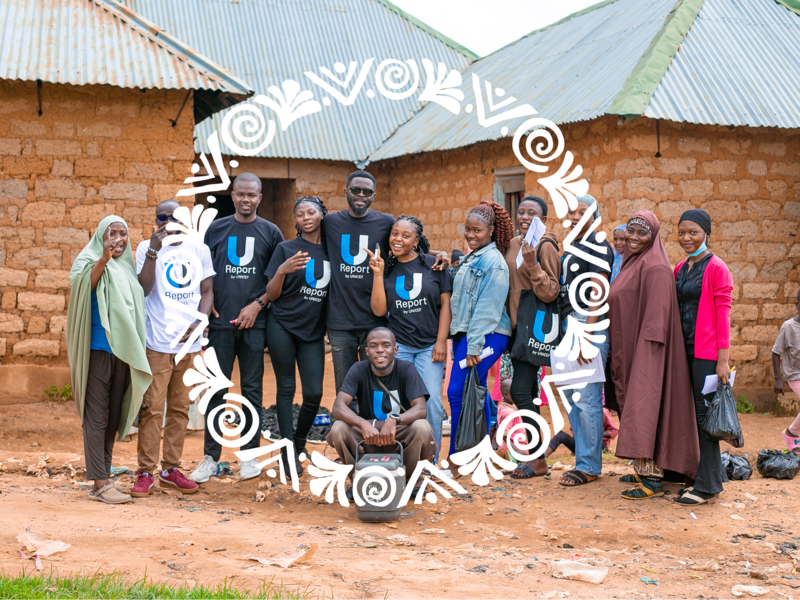 A group of young adults standing on the countryside and smilling at the camera