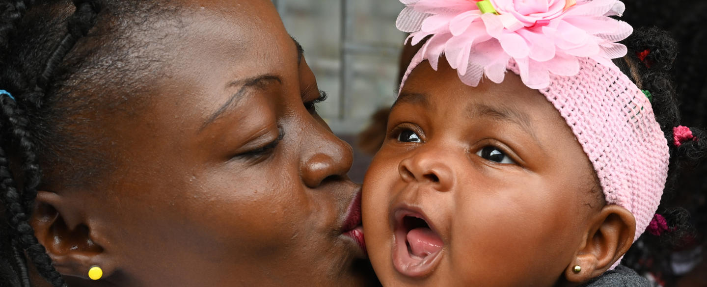 Mother kissing her baby girl